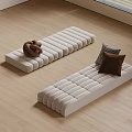 Beige Padded Floor Mats With Knitted Item And Cushions On Wooden Floor