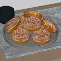 Tasty Glazed Donuts with Colorful Sprinkles on Wooden Table with Dark Cup and Blue Cloth