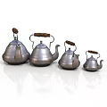 Set of Silver Teapots with Wooden Handles in Various Sizes Arranged Neatly