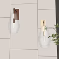 Modern Wall Sconces With Clear Glass Shade And Metal Base Mounted On White Tile Wall