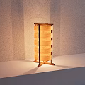 Natural Wooden Table Lamp With Stacked Panels And Warm Light On