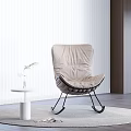 Modern Beige Leisure Chair With Black Metal Frame Round Rug And Side Table Plant