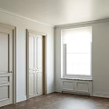 Cream White Hinged Doors With Decorative Panels In Light Wall Interior