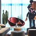 Modern Apartment With Glass Railing Staircase Sofa Colorful Pillows Chandelier Green Plants And Marble Floor