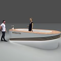 Curved Information Reception Desk With Staff Assisting Visitor In Lobby Area