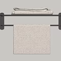 Patterned Light Colored Towel Hanging On Black Towel Rack With Folded Towels On Top