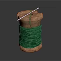 Wooden Spool Wound With Green Thread And Needle Against Dark Background