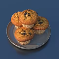Four Fresh Baked Muffins on Silver Plate with Dark Dried Fruits on Deep Blue Background
