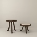 Two Different Size Wooden Stools With Round Light Seats And Dark Legs For Indoor Use