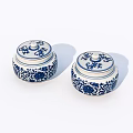Pair of Blue and White Ceramic Jars With Floral Patterns and Lids