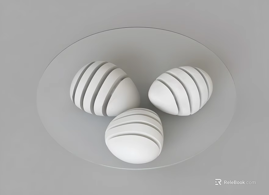 Round Transparent Coffee Table With Three White Striped Egg Shaped Objects 3d model 