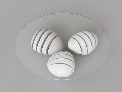 Round Transparent Coffee Table With Three White Striped Egg Shaped Objects 3d model