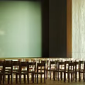 School Classroom Interior With Rows of Wooden Chairs Green Blackboard and Wooden Decorated Walls