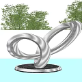 Modern Silver Intertwined Circular Ring Sculpture On Round Base With Trees Background