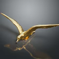 Golden Seagull Sculpture Flying With Outstretched Wings On Dark Background With Reflection
