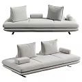 Modern Three Seater Sofa With Light Gray Upholstery And Comfortable Plush Cushions