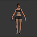 Woman in Black Sports Bra and Shorts Standing Against Grey Background