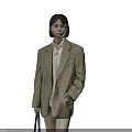 Woman in Plaid Blazer White Shirt Beige Pants Holding Gray Handbag Standing Against Gray Background