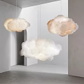 Cloud Shaped Pendant Lights Hanging In Modern Minimalist Interior With Soft Glow