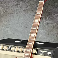 Red Electric Guitar Leaning On Black Beige Amplifier In Studio Setup