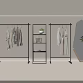 Modern Black Garment Racks With Hanging Clothes Mannequin Potted Plant And Round Mirror