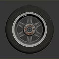 Car Tire With Alloy Wheel Rim And Red Center Cap On Gray Background