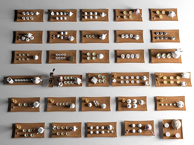 Assorted Tea Sets Neatly Arranged On Brown Trays For Display Collection 3d model