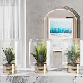 Transparent Glass Vases With Gold Bases Holding Green Plants In Modern Interior Decor