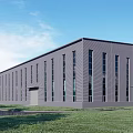 Modern Gray Industrial Factory Building With Large Windows Metal Exterior Green Lawn And Blue Sky
