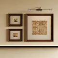 Abstract Painting in Brown Frame with Two Smaller Brown Frames and Wall Lamp on Beige Wall