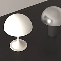 White And Silver Mushroom Shaped Table Lamps On Dark Wooden Surface