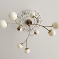 Modern Chandelier with White Spherical Shades and Golden Metal Arms Mounted on Ornate Ceiling Plate