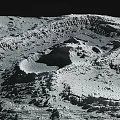 Lunar Landscape With Rugged Terrain Large Impact Craters And Gray Surface