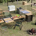 Camping Campsite With Outdoor Tables Chairs Cooler Food And Campfire Setup