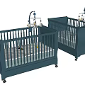 Two Blue Wooden Baby Cribs With Decorative Mobiles and Drawers for Nursery