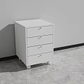 Modern White Three Drawer Cabinet Standing Against Wall On Gray Floor