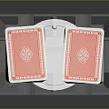 Two Red Playing Cards with Intricate Back Design Held in Silver Card Holder