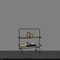 Three Tier Rolling Cart With Black Frame Ceramic Vase And Book On Gray Floor
