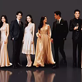 Group of Well Dressed People in Formal Suits and Evening Gowns Posing Together