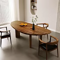 Wooden Oval Dining Table with Black Leather Chairs Fruit Plate and Green Plant Vase