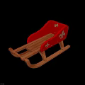 Traditional Red Wooden Sled With Decorative Patterns And Curved Wooden Runners