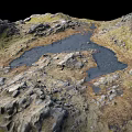 Natural Rocky Terrain With Small Water Pools And Green Grass Patches