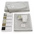 Grey Waffle Textured Towels Neatly Stacked With Decorative Gift Boxes