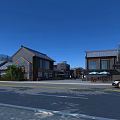 Traditional Commercial Street Featuring Classic Architecture Pedestrians Outdoor Café Seating Parked Cars Under Blue Sky