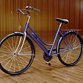 Purple Classic Bicycle With Black Seat On Wooden Floor And Wall