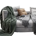 Cozy Multi Seater Sofa With Soft Gray Blankets And Beige Green Cushions