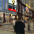 Bustling Commercial Street with Pedestrians Shops Billboards Tall Buildings and Green Plants