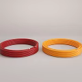 Red and Yellow Coiled Flexible Hoses on Gray Surface with Secure Fastening