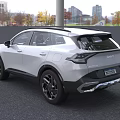 White Kia SUV With Distinctive Grille Alloy Wheels And Modern Design In Outdoor Setting