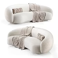 Modern Cream Sectional Sofa With Soft Textured Fabric Curved Design Throw Blanket And Accent Pillows